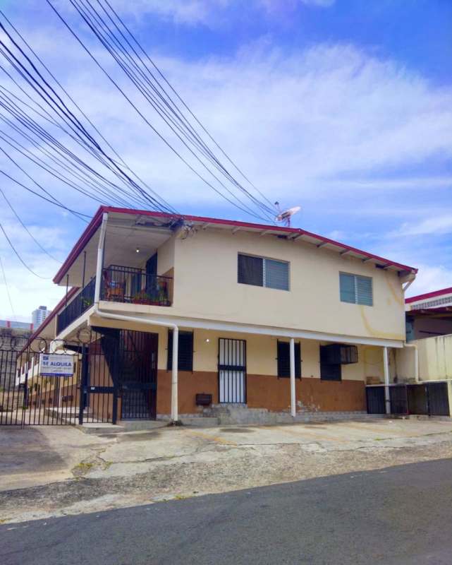 Interior open-plan living space with kitchen divider and tiled floors in affordable Rio Abajo apartment Panama