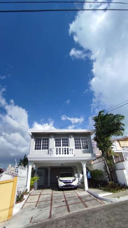 Spacious kitchen with light wood cabinetry, granite counters in Betania Panama duplex