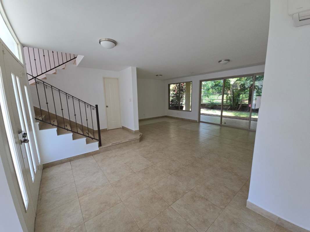 Spacious living room with sliding doors to garden Embassy Gardens house for sale Albrook Panama