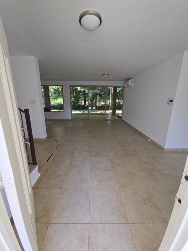 Spacious living room with sliding doors opening to garden Embassy Gardens Clayton Panama