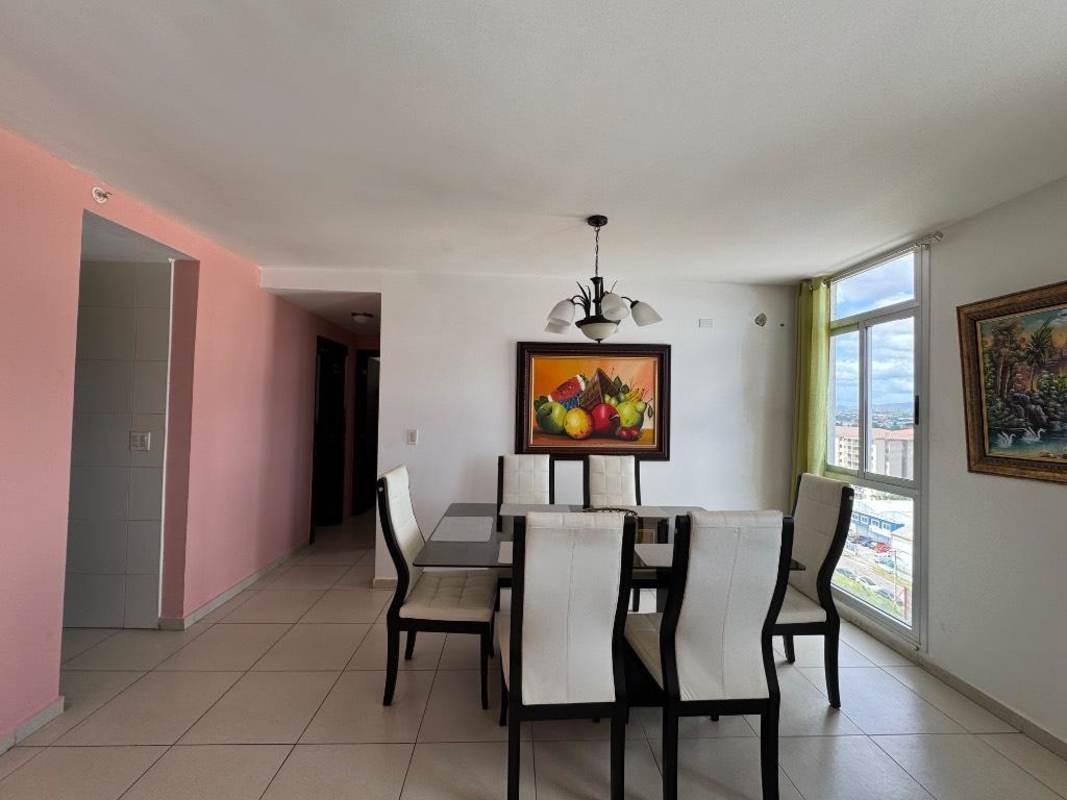 Dining area with large window, natural light, glass table furniture in PH Torres del Este Panama
