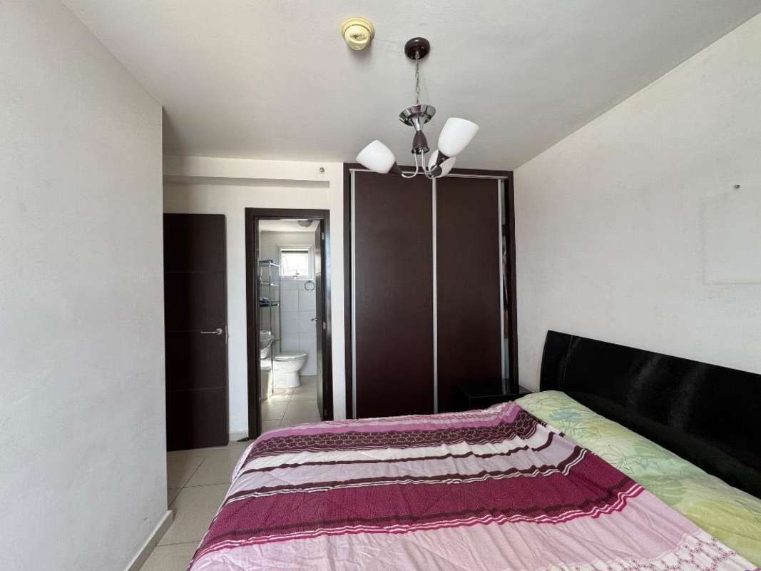 Bedroom with bed, built-in closet, attached bathroom PH Torres del Este Tocumen Panama