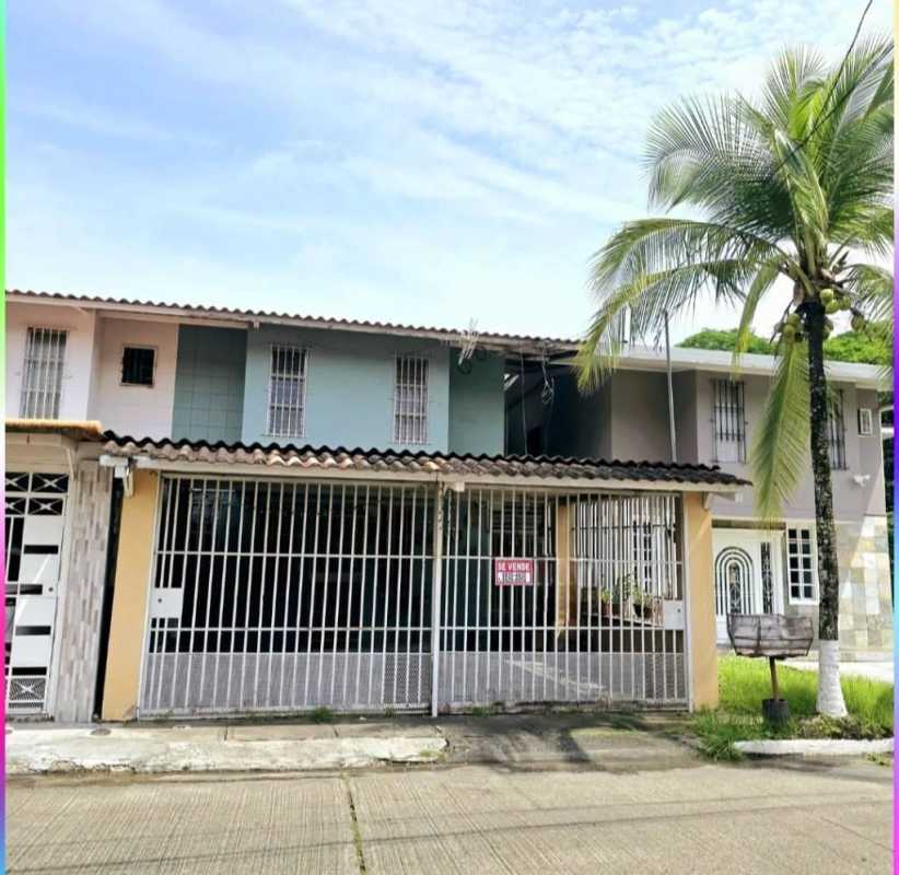 Two-story duplex house with gated entrance and palm tree in Condado del Rey Panama