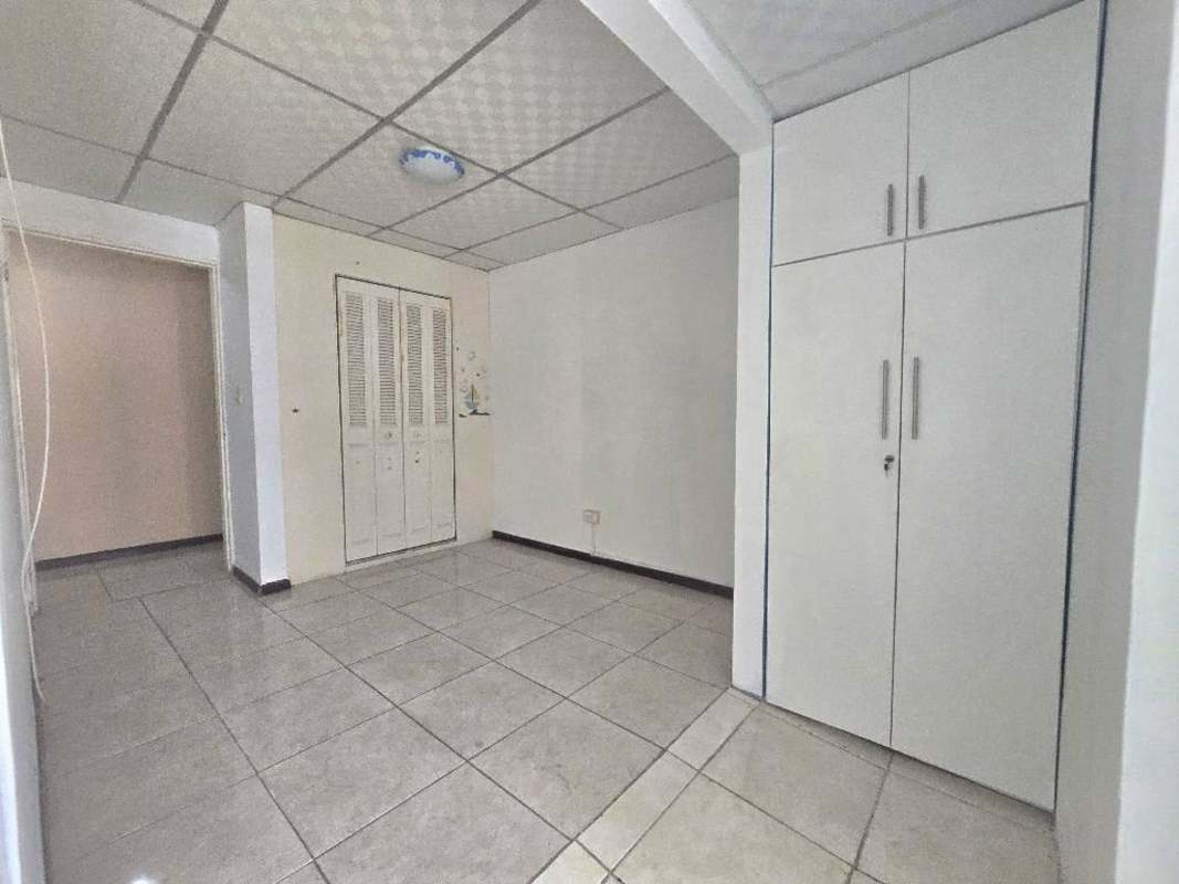 Bedroom featuring built-in closet storage and tile floors in Condado del Rey Panama