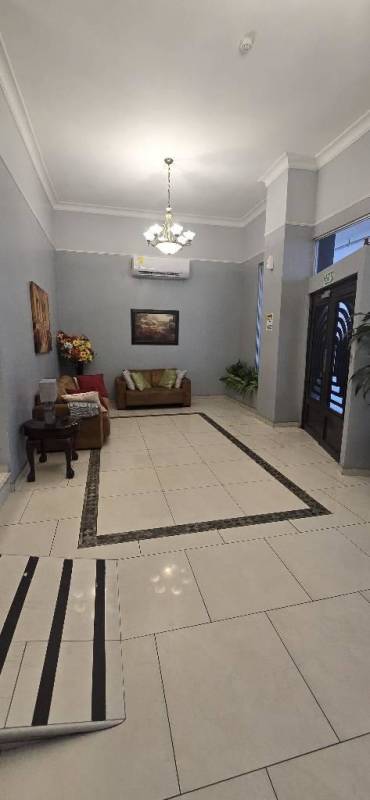 Kitchen with granite countertops, stove, oven, microwave, and tile backsplash in PH Victory Tower, Panama City