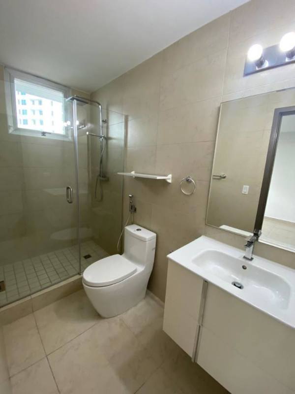 Modern bathroom with glass shower, sleek vanity, neutral tiles PH Lumiere Costa del Este Panama