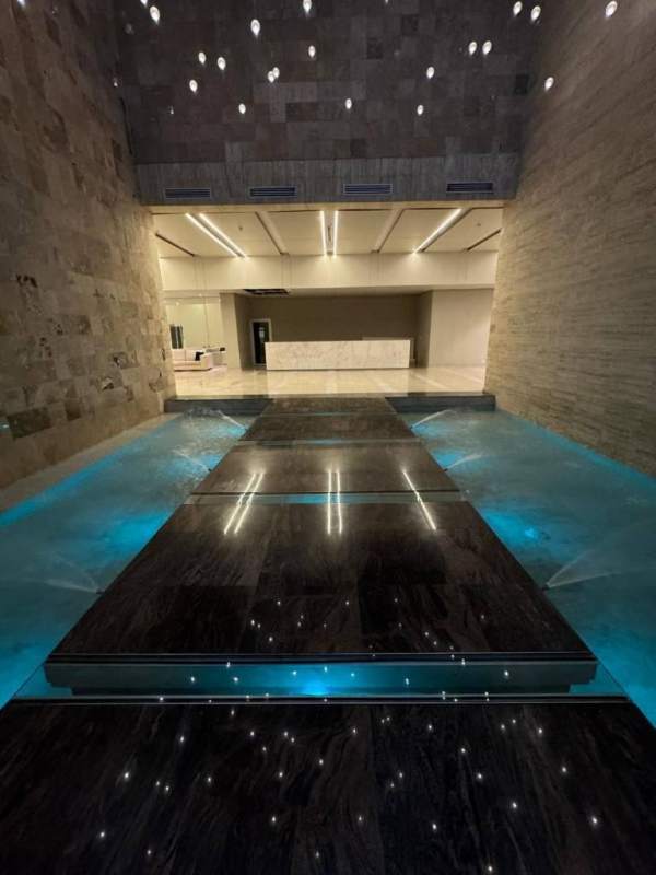 Lobby interior with cream sofas blue chairs marble floors in PH Lumiere Costa del Este Panama