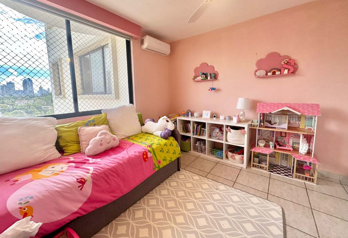 Kids bedroom with large window pink accents toys and ocean view PH Luna del Mar Panama