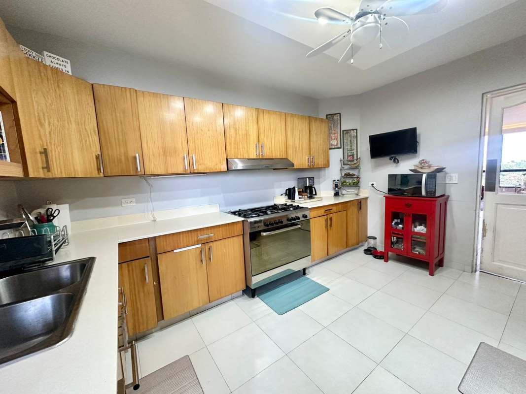 Kitchen with granite counters wood cabinets appliances PH Luna del Mar Coco del Mar Panama