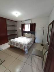 Living room with green sofas, tile flooring, bright space rental Bugaba
