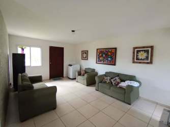 Laundry area equipped with washing machine dryer in furnished rental home Bugaba