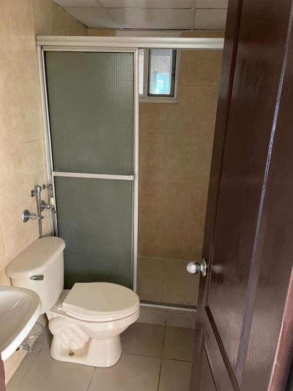 Simple bathroom with frosted glass sliding shower doors, wall tiles, at PH Mallorca Park Los Andes Panama City