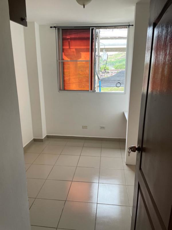 Small bedroom with tiled flooring and window view to urban area PH Mallorca Park Los Andes Panama