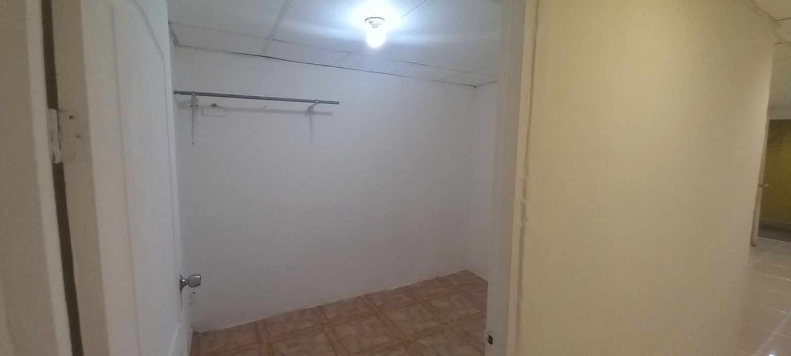 Minimalist empty closet space with white walls and tiled floors in Colonias del Prado