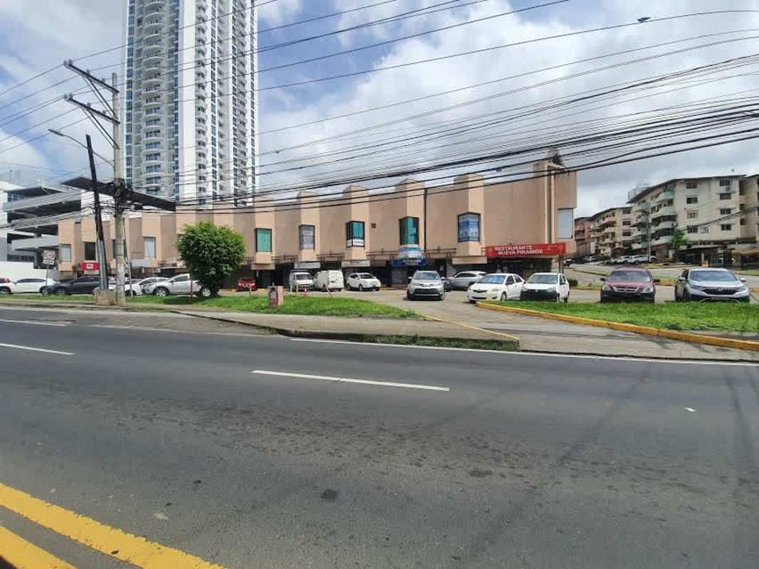 Mixed-use commercial building with adjacent residential tower and parking on Via España Panama