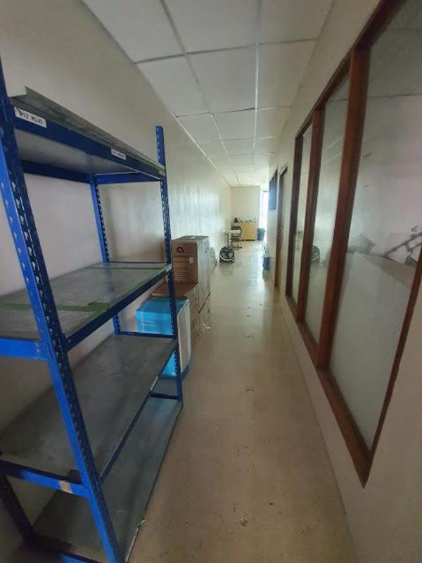 Interior hallway corridor with windows and shelving inside commercial building Panama