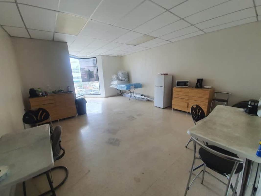Spacious break room with table, chair, appliances and window in commercial unit for sale Panama City