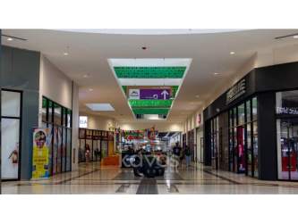 Interior shopping mall corridor with polished floors and retail stores Chiriquí Mall David Panama
