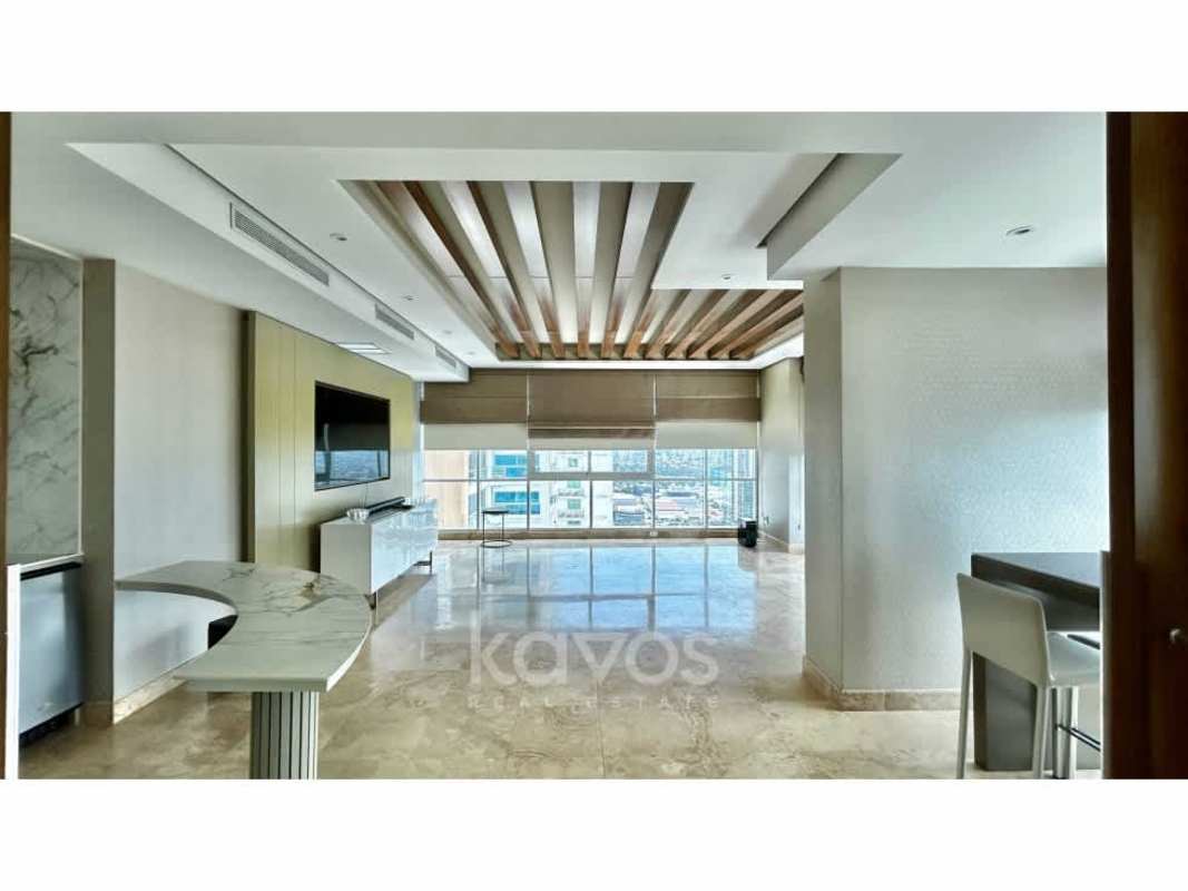 Penthouse master bedroom with ocean view window, king bed and marble floors at PH Titanium Costa del Este Panama