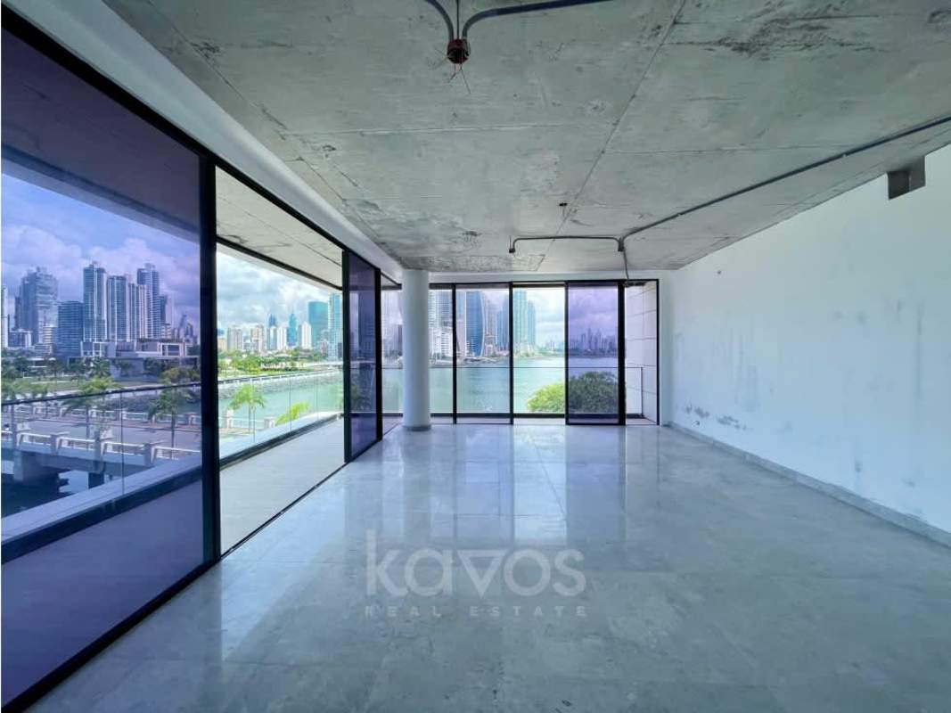 Large open living area with floor-to-ceiling windows showing panoramic marina and city skyline on Ocean Reef Island