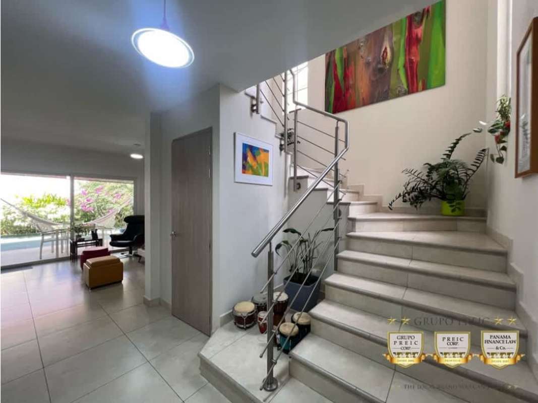 Spacious living room with sliding glass door and colorful furniture Reserva de Versalles Panama