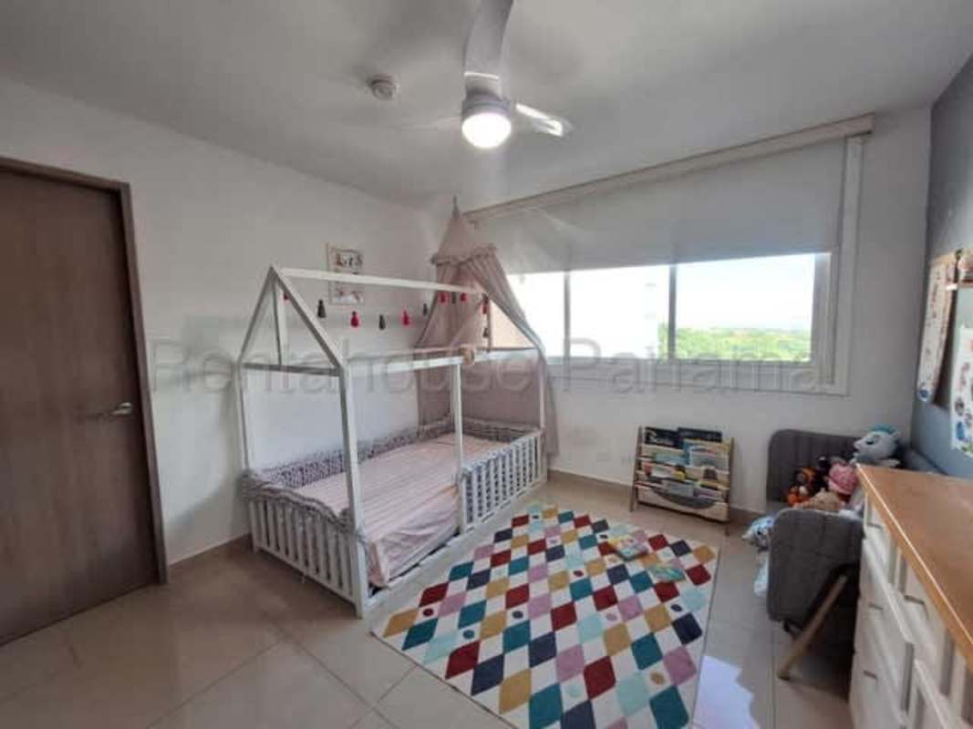 Outdoor swimming pool surrounded by lounge chairs and gardens