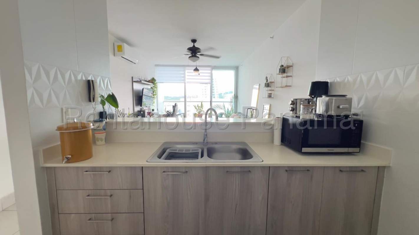 Bathroom with glass shower enclosure, beige tile, large mirror at PH Vivendi Green Panama City
