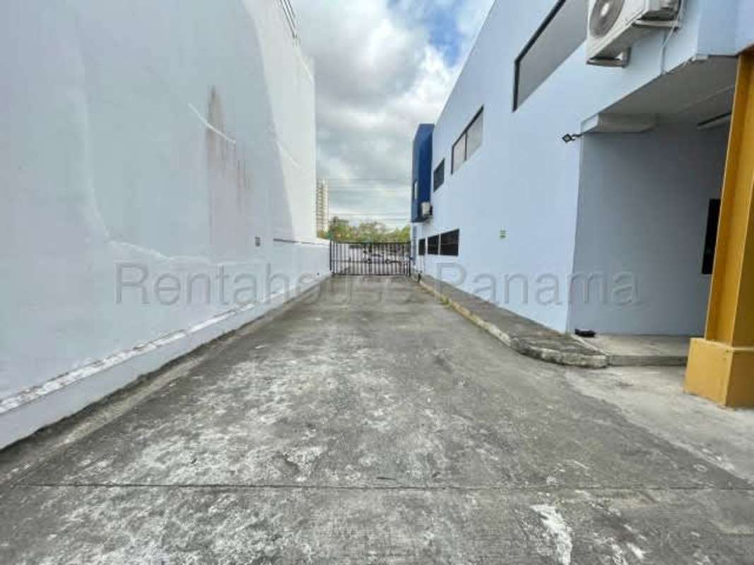 Exterior of commercial warehouse and offices with secure driveway and blue facade in Costa del Este Panama