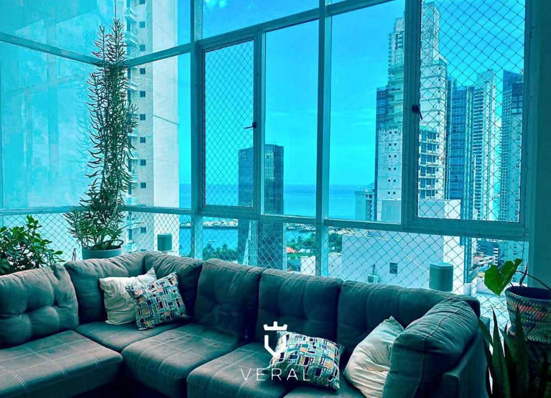 High-rise condo living room with panoramic views of ocean and skyline at PH Blue Park Panama