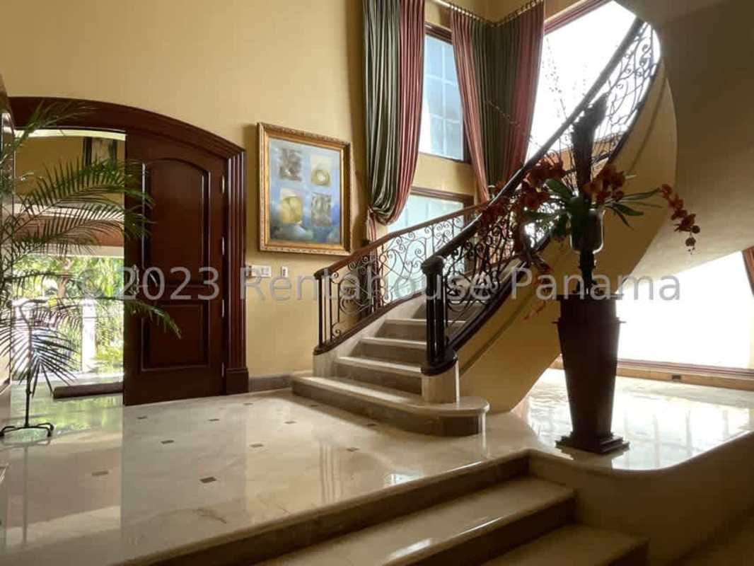 Traditional dining room with tray ceiling, chandelier and marble floors in luxury house El Carmen Panama