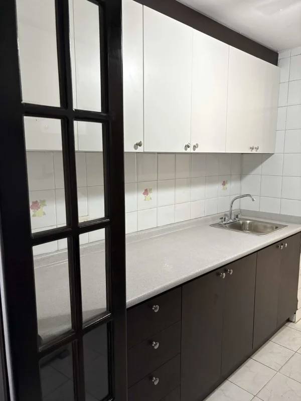 Renovated kitchen with modern cabinets, refrigerator, and stove in PH Plaza Dos Mares Villa de las Fuentes