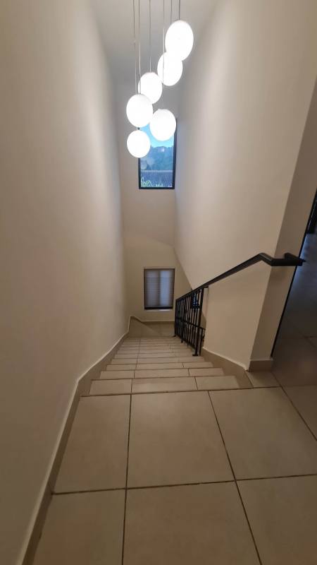 Contemporary staircase design with pendant lights in townhouse PH Embassy Club Panama