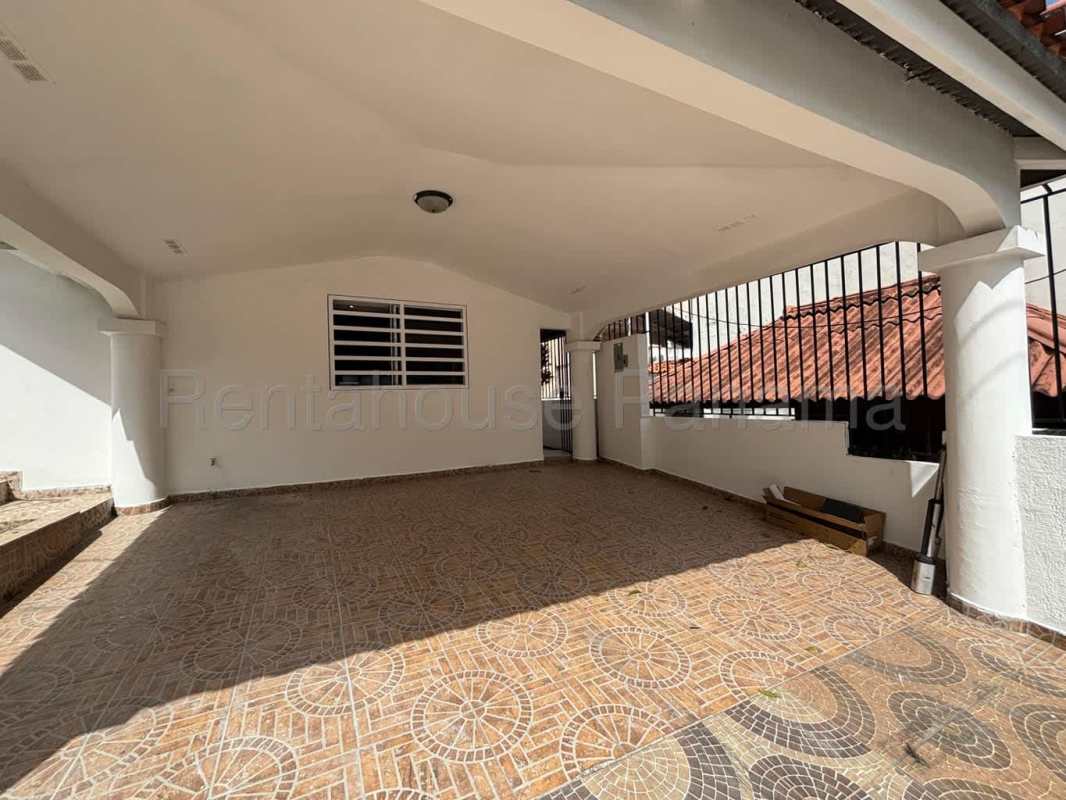 Covered patio or carport area with decorative tile, archways, and window bars at Altos de Santa María House for Rent