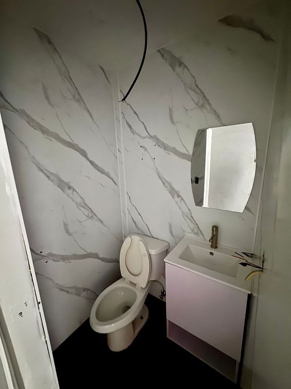 Finished bathroom commercial space marble tile vanity mirror Plaza Corner 68 Panama