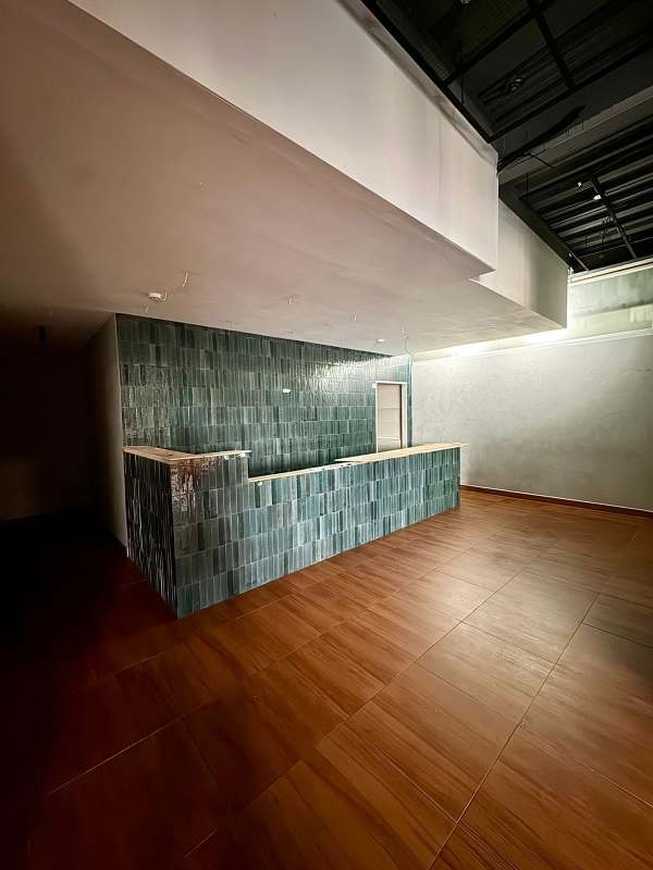 Green subway tile wall bathroom wood tile floors contemporary sink mirror Plaza Corner 68 Panama