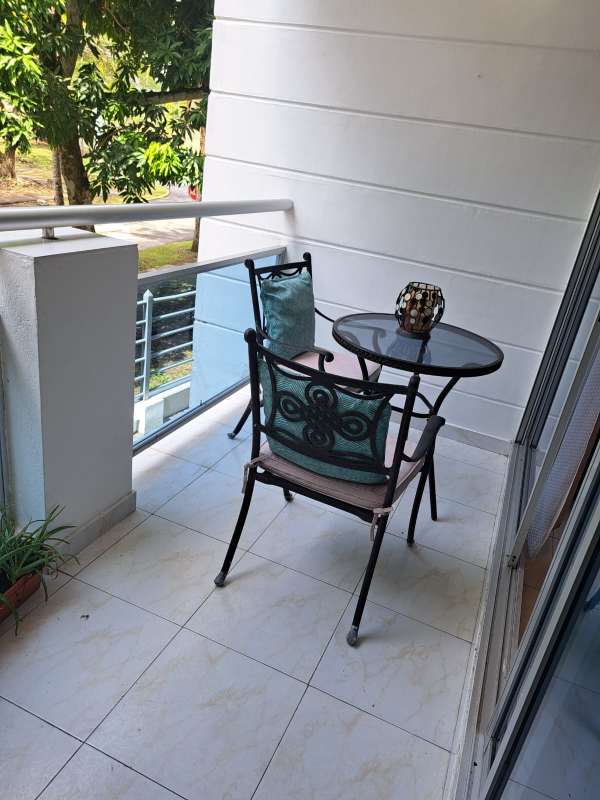 Balcony with glass railing, table, chairs, greenery view PH Clayton Tower Panama