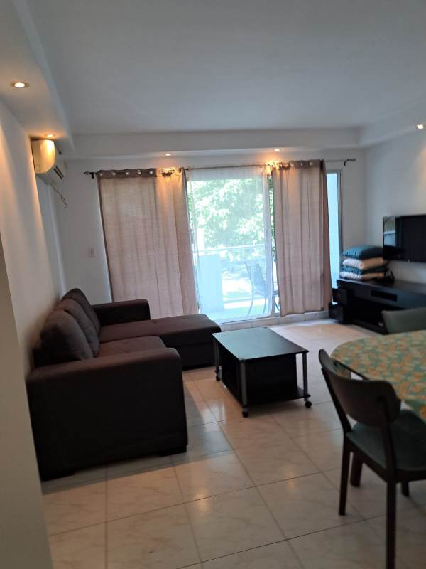 Open concept kitchen with upper and lower beige cabinetry, granite counters, appliances in Clayton Tower