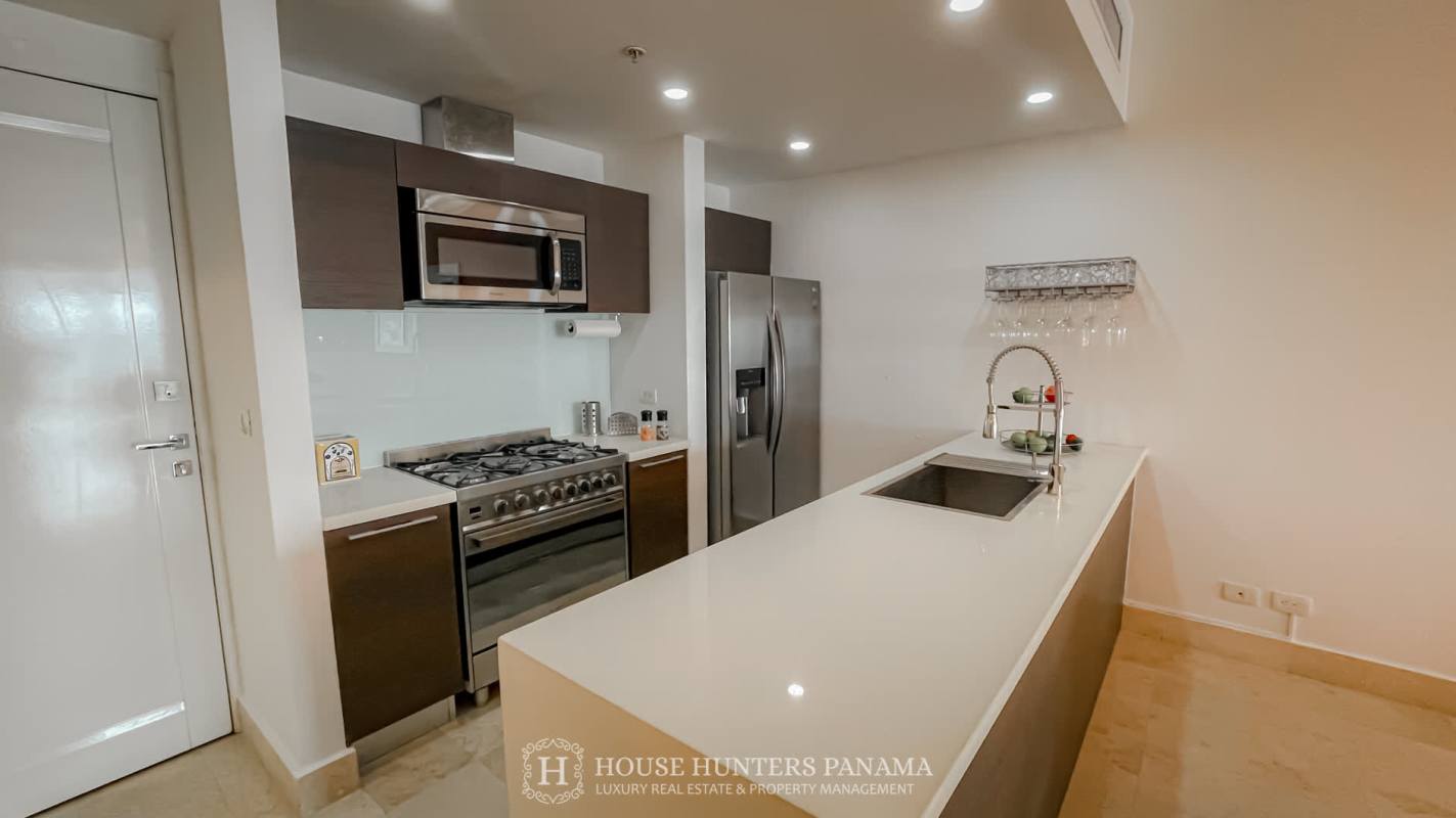 Modern open-plan kitchen and living area with island at Yoo Panama tower