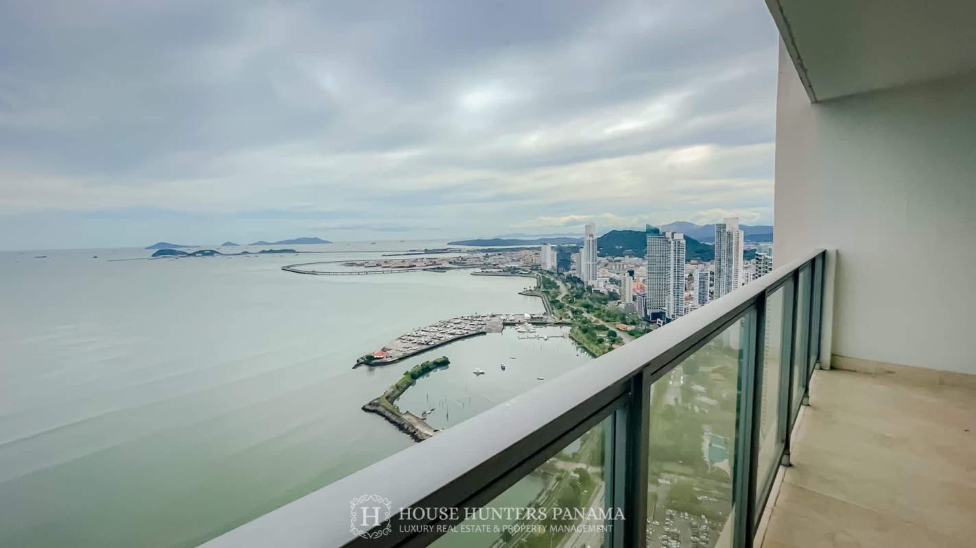 Balcony with glass railing overlooking ocean and Panama skyline at Yoo Panama