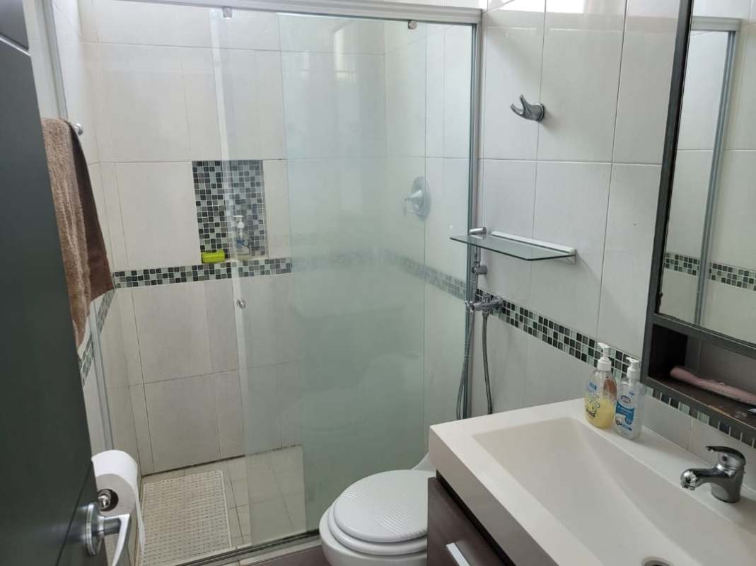 Contemporary bathroom with mosaic tiles, glass shower, modern sink at Edison Park rental apartment