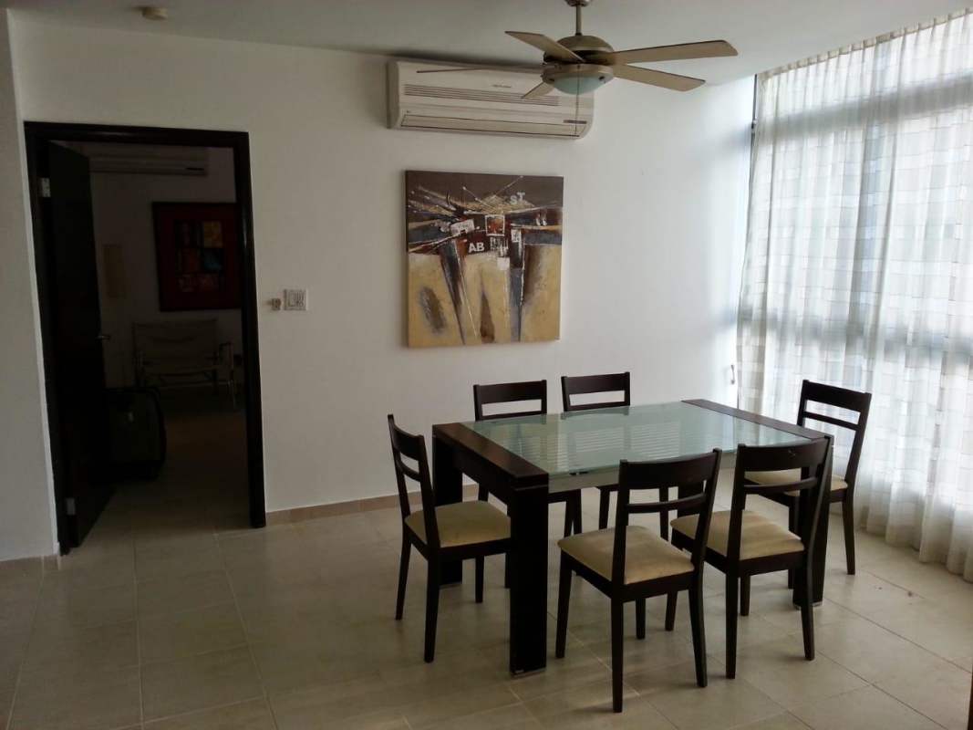 Dining space with glass table ocean views in apartment PH Bayfront Panama City