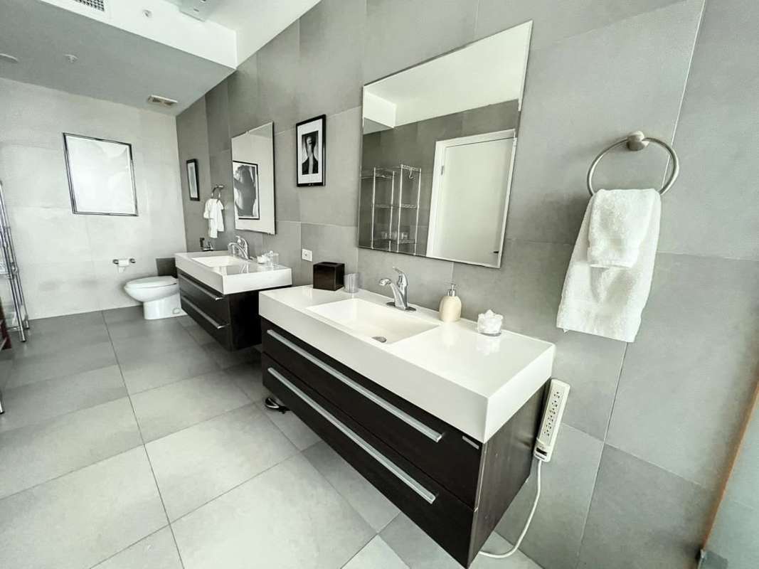 Modern bathroom with double sinks, quartz countertops, premium fixtures PH BICSA Tower