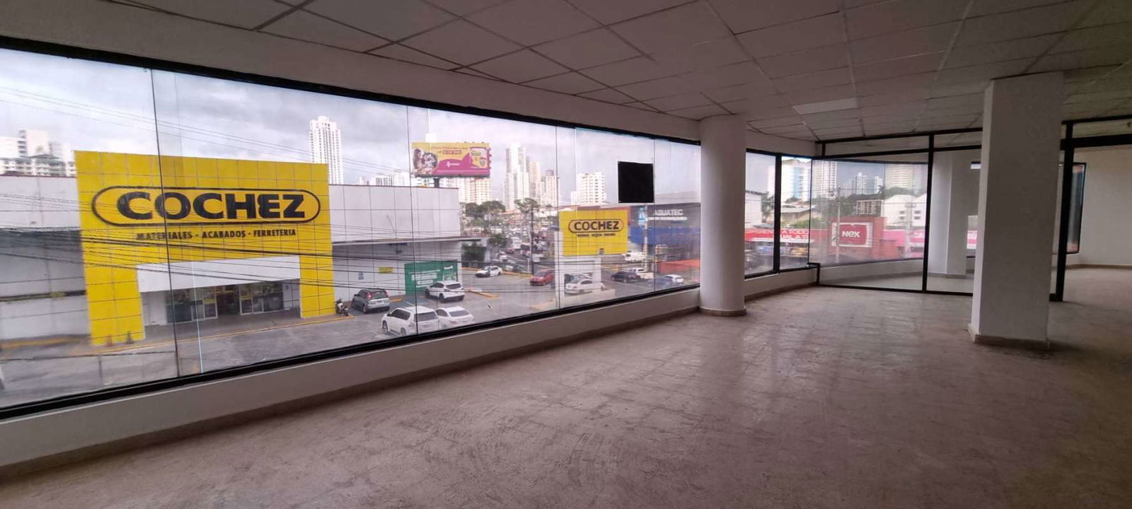 Empty commercial retail office with large windows and tiled ceiling at San Fernando Plaza Panama City