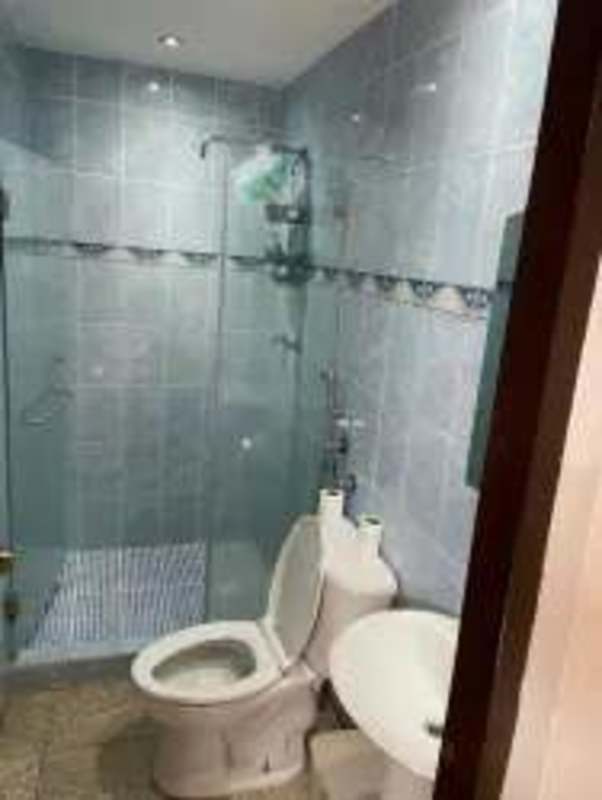Contemporary bathroom with glass shower, blue tiles, modern fixtures in Tocumen house for sale Panama