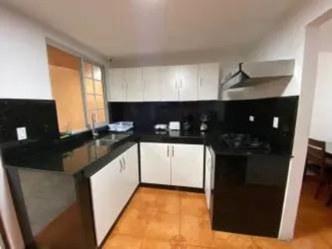 Contemporary kitchen with granite counters, gas stove, upper and lower cabinets, at house with pool Tocumen Panama