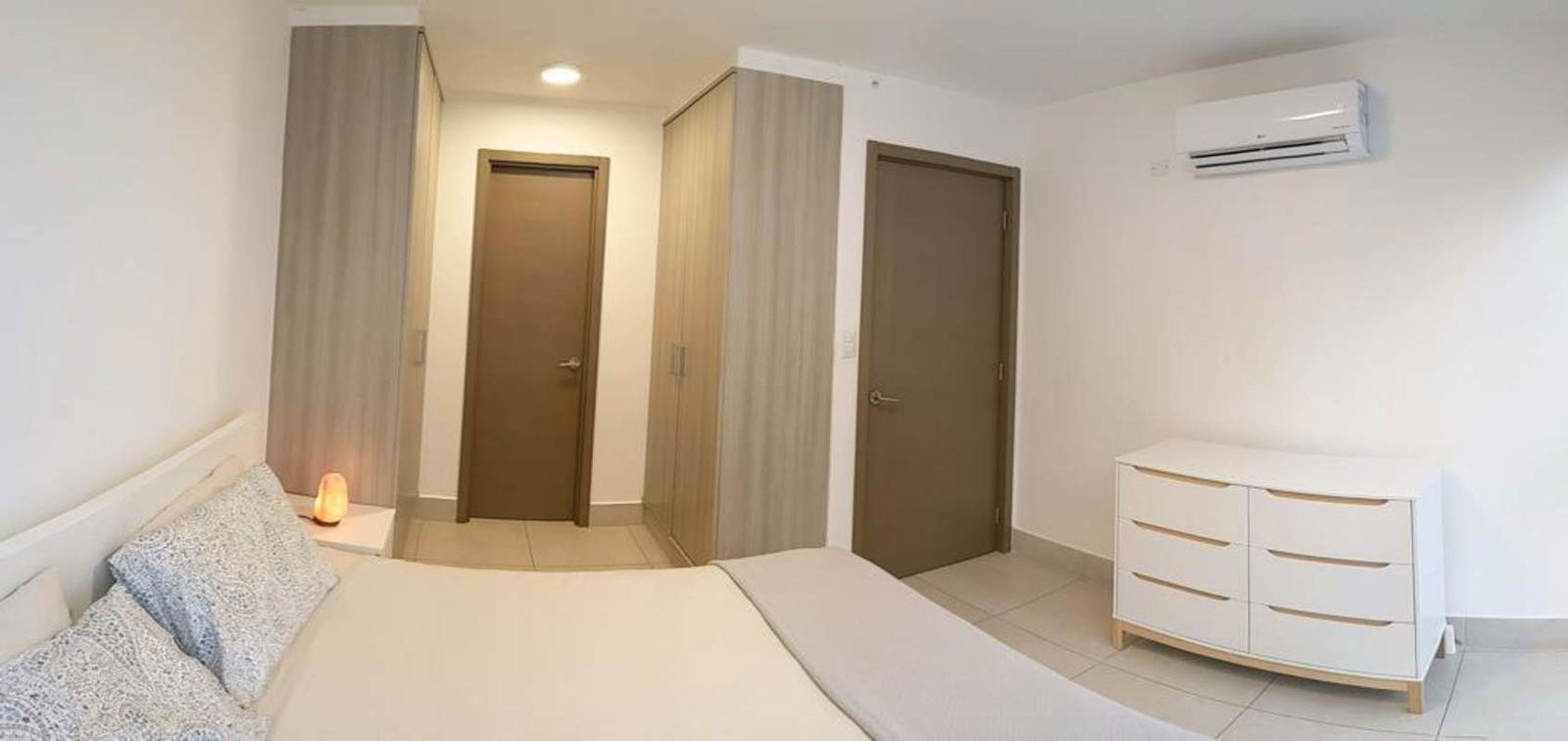 Spacious bedroom with floor to ceiling windows and skyline view in PH Park City