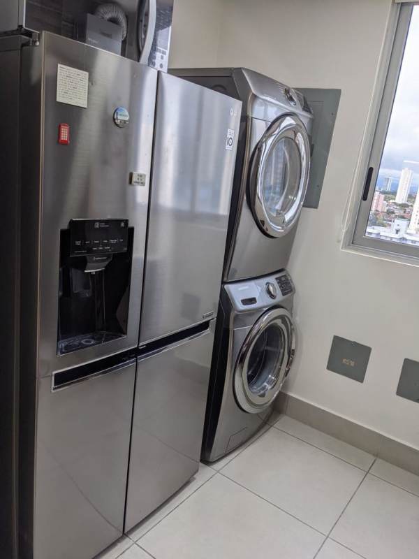 Laundry area with stacked washer dryer equipped PH Park City Panama rental