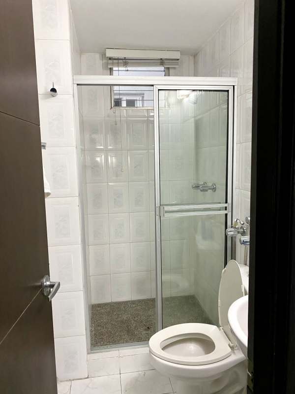 Bathroom with glass shower screen, toilet, and wall tiles in Plaza Dos Mares Betania Panama