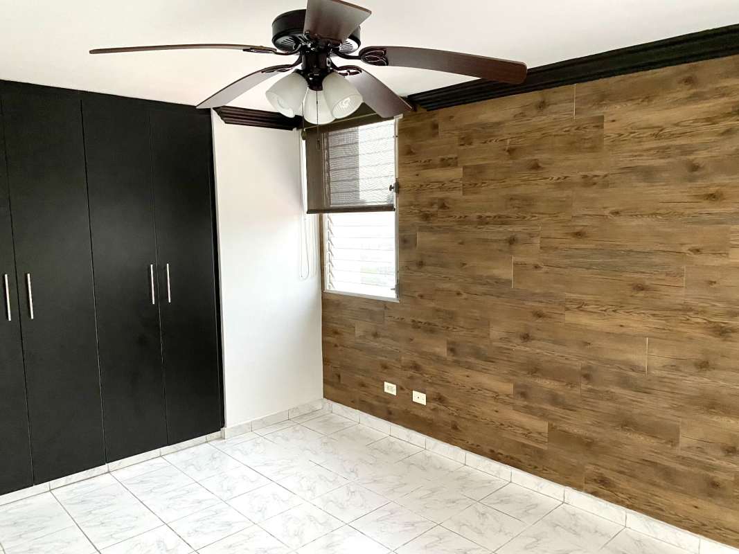 Bedroom featuring accent wall, closet storage, ceiling fan, tiled floor at PH Plaza Dos Mares I Betania