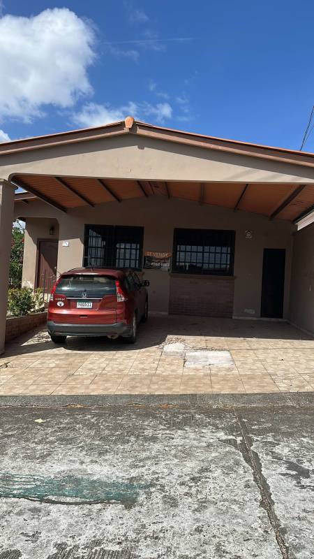 Single-story house with covered parking and tiled driveway in Brisas del Golf San Antonio Panama